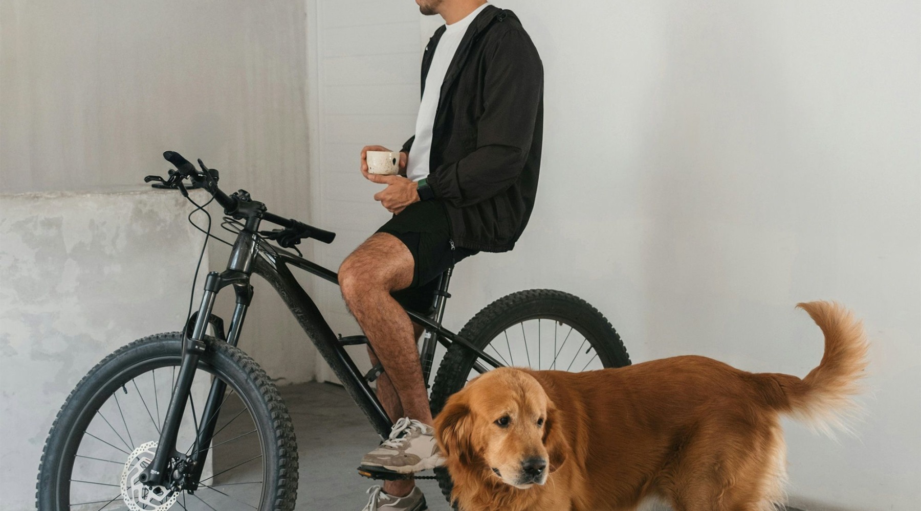 man on bike with dog