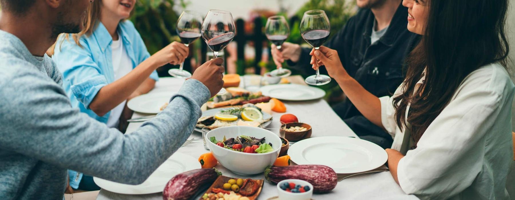 a group of people having a meal around an outdoor table