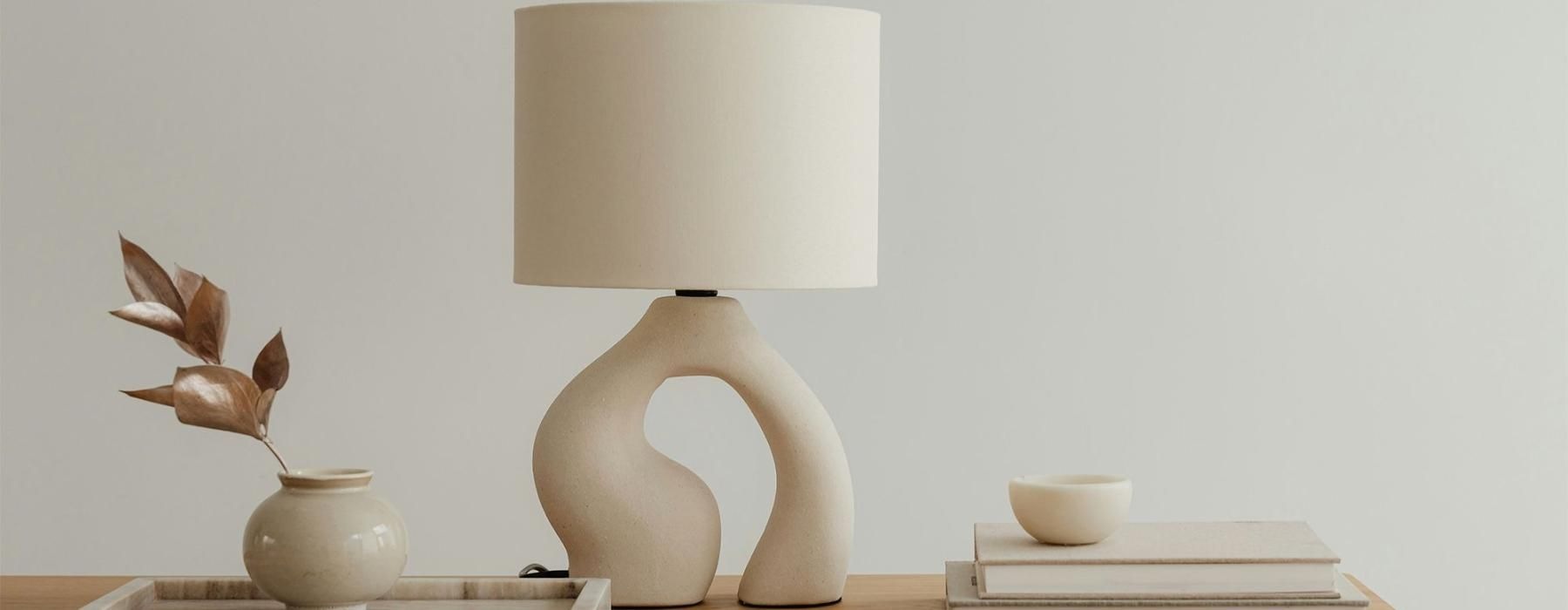 a lamp, stack of books, and decor